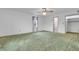 Spacious bedroom featuring green carpet, ceiling fan, and natural light at 5301 Old Smith Valley Rd, Greenwood, IN 46143
