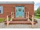 Inviting front entrance with brick steps, black railings, and a charming wreath on the light blue door at 5301 Old Smith Valley Rd, Greenwood, IN 46143