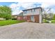 Two-story home featuring brick and siding facade, blue accents, and gravel driveway; situated on a lot at 5301 Old Smith Valley Rd, Greenwood, IN 46143