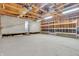 Unfinished garage interior featuring exposed wood frame, concrete floor, and built-in shelves for storage at 5301 Old Smith Valley Rd, Greenwood, IN 46143