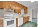 Practical kitchen featuring wooden cabinetry, essential white appliances, and an efficient layout at 5301 Old Smith Valley Rd, Greenwood, IN 46143