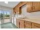 Functional kitchen featuring wooden cabinets, essential appliances, and access to an outdoor deck at 5301 Old Smith Valley Rd, Greenwood, IN 46143