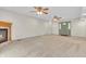 Open living room featuring a fireplace, carpeted floors, and a door leading to another room at 5301 Old Smith Valley Rd, Greenwood, IN 46143
