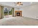 Bright living room with a fireplace and a sliding glass door leading to an outdoor deck at 5301 Old Smith Valley Rd, Greenwood, IN 46143