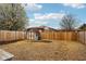 Fenced-in backyard with a wooden shed, gravel, and some mulched area at 5431 Carlton Ct, Indianapolis, IN 46224