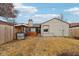 Backyard featuring a hot tub, gravel, partial fencing, and outdoor lighting at 5431 Carlton Ct, Indianapolis, IN 46224
