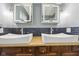 Bathroom featuring dual square vessel sinks, modern lighting, dark backsplash, and wooden cabinets at 5431 Carlton Ct, Indianapolis, IN 46224