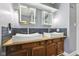 Updated bathroom featuring dual vessel sinks, illuminated medicine cabinets, and blue subway tile at 5431 Carlton Ct, Indianapolis, IN 46224