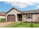 Charming single-story home with a cozy front porch and attached garage at 5431 Carlton Ct, Indianapolis, IN 46224