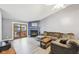 Comfortable living room with a fireplace, plush sofa, and backyard access at 5431 Carlton Ct, Indianapolis, IN 46224