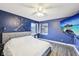 Comfortable bedroom features blue walls, wood-look floors, and modern decor at 5431 Carlton Ct, Indianapolis, IN 46224