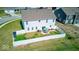 Aerial view of fenced backyard with patio, lawn, storage, and outdoor dining at 5839 Altar Bell Cir, Greenwood, IN 46143