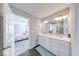 Bathroom featuring double sinks, a large mirror and doorway to the main bedroom at 5839 Altar Bell Cir, Greenwood, IN 46143