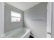 A bathtub positioned near a window and towel bar, ideal for relaxation at 5839 Altar Bell Cir, Greenwood, IN 46143