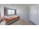 Bright bedroom featuring neutral walls, carpet flooring, and a sunny window at 5839 Altar Bell Cir, Greenwood, IN 46143