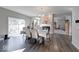 Open dining area with hardwood floors, fireplace and view to the backyard patio at 5839 Altar Bell Cir, Greenwood, IN 46143