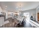 Bright dining area featuring hardwood floors, modern chandelier, and sliding door access to patio at 5839 Altar Bell Cir, Greenwood, IN 46143