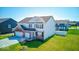 Attractive home with a lush lawn, mature landscaping, and a three-car garage at 5839 Altar Bell Cir, Greenwood, IN 46143