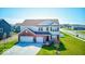 Inviting two-story home with a well-manicured lawn and three-car garage at 5839 Altar Bell Cir, Greenwood, IN 46143