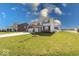 Charming home featuring a three-car garage, manicured lawn, and mature landscaping at 5839 Altar Bell Cir, Greenwood, IN 46143