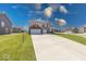 A two-story home featuring a large driveway and well-maintained lawn at 5839 Altar Bell Cir, Greenwood, IN 46143
