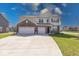 A two-story home boasting a spacious three-car garage and a beautifully paved driveway at 5839 Altar Bell Cir, Greenwood, IN 46143