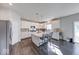 Spacious kitchen with island, barstool seating, stainless steel refrigerator, and white cabinets at 5839 Altar Bell Cir, Greenwood, IN 46143