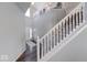 Grand staircase with white railings and hardwood floors leading to the upper level at 5839 Altar Bell Cir, Greenwood, IN 46143
