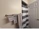 Cozy bathroom featuring a striped shower curtain, towel rack, and clean white door at 6005 Wingedfoot Ct, Indianapolis, IN 46254