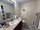 Functional bathroom with a vanity, mirror, toilet, and neutral tones at 6005 Wingedfoot Ct, Indianapolis, IN 46254