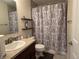 Well-lit bathroom featuring a vanity with sink, decorative shower curtain, and modern fixtures, offering a relaxing and stylish space at 6005 Wingedfoot Ct, Indianapolis, IN 46254