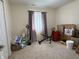 Bedroom with neutral carpeting and large window. Great potential to customize this room into your dream space at 6005 Wingedfoot Ct, Indianapolis, IN 46254