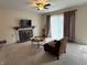 Spacious living room with a decorative fireplace, neutral carpeting, and ample natural light, creating a warm and welcoming atmosphere at 6005 Wingedfoot Ct, Indianapolis, IN 46254