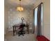 Cozy office area featuring a unique chandelier, accent wall and ample natural light, creating a functional and inspiring workspace at 6005 Wingedfoot Ct, Indianapolis, IN 46254