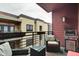 This balcony features outdoor seating, a table, grill and building views at 622 E 10Th St # 303, Indianapolis, IN 46202