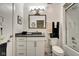 This bathroom features a single vanity, mirror, toilet and shower with glass door at 622 E 10Th St # 303, Indianapolis, IN 46202