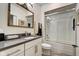 This bathroom features a single vanity, mirror, toilet and shower with glass door at 622 E 10Th St # 303, Indianapolis, IN 46202