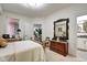 This bedroom features a brass-colored four poster bed and ensuite bathroom at 622 E 10Th St # 303, Indianapolis, IN 46202