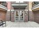 The entrance to 622 showcases brick walls and a glass door with a gray canopy at 622 E 10Th St # 303, Indianapolis, IN 46202