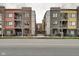 Street view featuring modern condominium buildings with brick facades, symmetrical window layouts, and professional landscaping at 622 E 10Th St # 303, Indianapolis, IN 46202