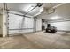 This garage features a car, shelving for storage and a roll-up door at 622 E 10Th St # 303, Indianapolis, IN 46202