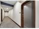 Hallway view with carpet, lighting, door entrance, and neutral wall colors in a clean, modern condominium at 622 E 10Th St # 303, Indianapolis, IN 46202