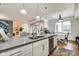 Modern kitchen features stainless steel appliances, white cabinetry, and a large center island at 622 E 10Th St # 303, Indianapolis, IN 46202