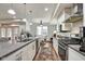 Modern kitchen features stainless steel appliances, white cabinetry, and a large center island at 622 E 10Th St # 303, Indianapolis, IN 46202