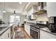 Modern kitchen with stainless appliances, white cabinets, sleek countertops, and breakfast nook at 622 E 10Th St # 303, Indianapolis, IN 46202