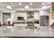 Modern kitchen featuring white cabinets, stainless steel appliances, and a large island with sink at 622 E 10Th St # 303, Indianapolis, IN 46202