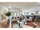Spacious living room with hardwood floors, sofas, and a view of the dining and kitchen areas at 622 E 10Th St # 303, Indianapolis, IN 46202