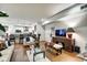 Open-concept living area with hardwood floors, sofas, and a view of the modern kitchen at 622 E 10Th St # 303, Indianapolis, IN 46202