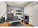 This office features wood floors, grey walls, and shelves with decorative items at 622 E 10Th St # 303, Indianapolis, IN 46202
