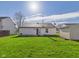 Expansive backyard featuring a well-maintained lawn, a patio, and a detached storage shed at 6233 Boulder Dr, Anderson, IN 46013